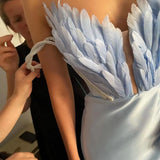 Feathers Tug On The Ground To Open The Robe